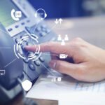 close up employee call center man hand point to press button number on telephone office desk with virtual communication technology concept